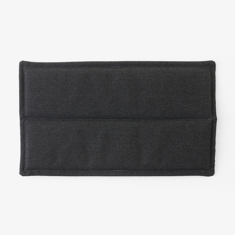 Black textured fabric with a smooth finish and subtle stitching detail, featuring a minimalist design.