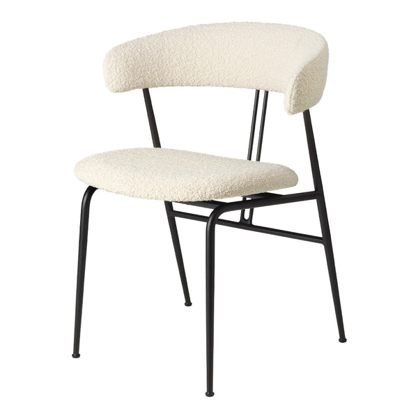 Cream upholstered chair with a curved backrest and black metal frame. Minimalist design with soft textures.