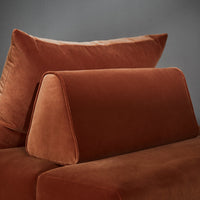 Soft rust-colored velvet cushions, featuring rich textures and sleek, modern lines against a neutral backdrop.