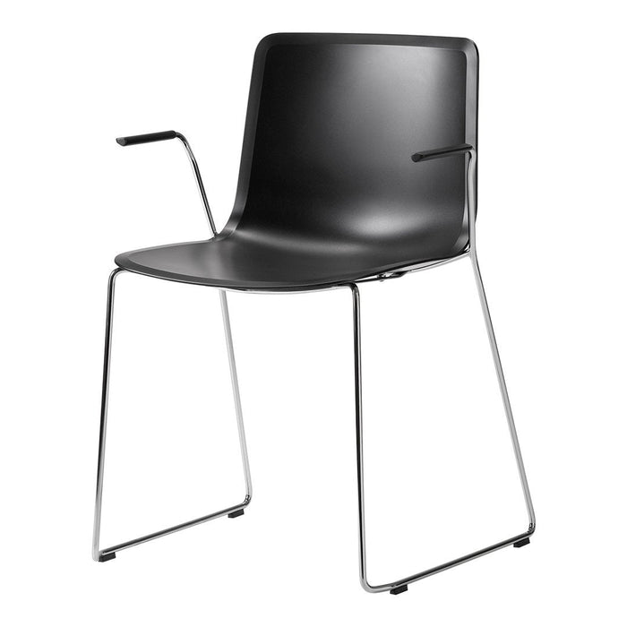 Black plastic chair with sleek design and chrome legs, featuring minimalist lines and a modern aesthetic.