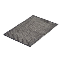 Gray and black woven rug with a textured pattern and contrasting border design. Ideal for modern decor.