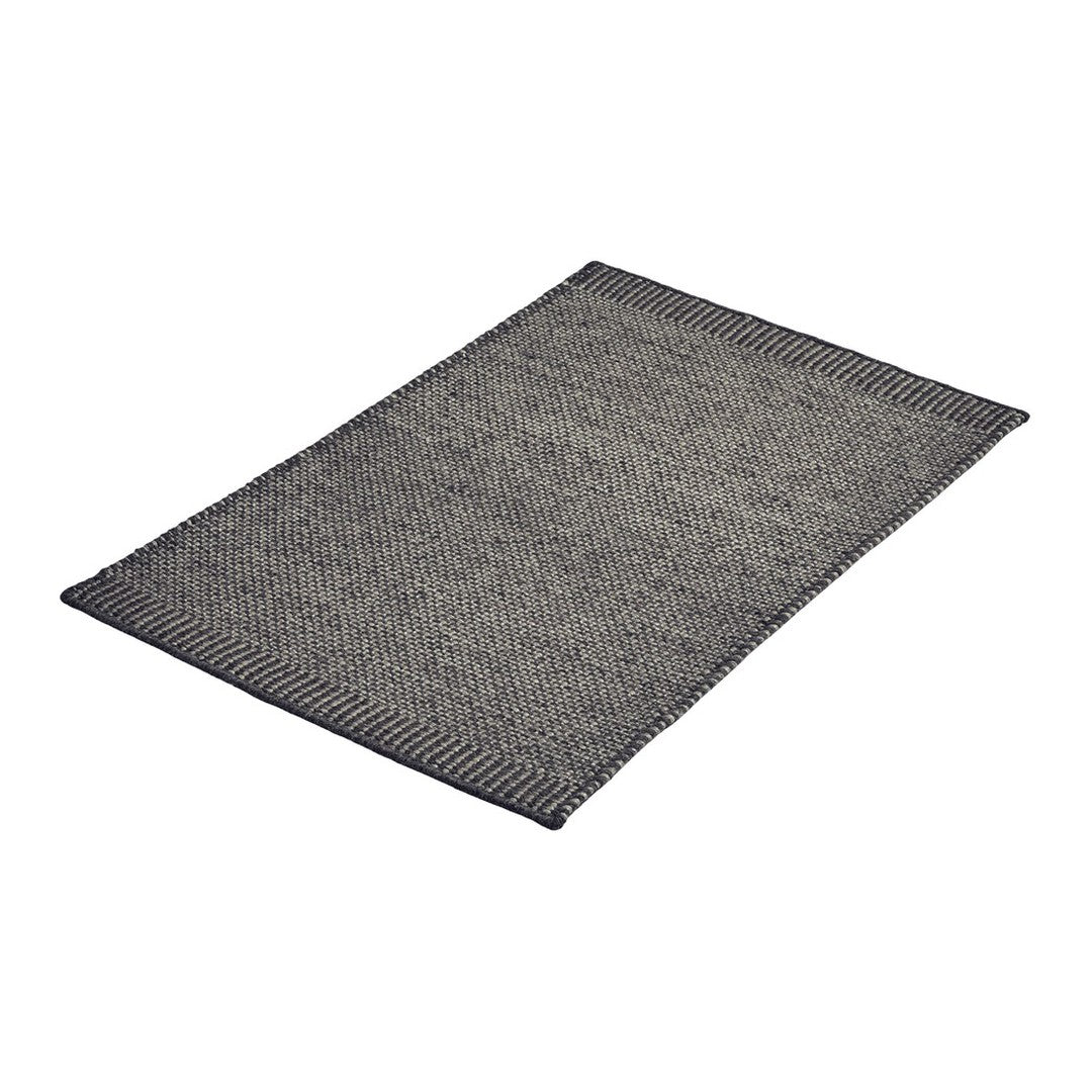 Gray woven rug with a subtle textured pattern and dark edges, perfect for modern decor.