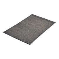 Gray woven rug with a subtle textured pattern and dark edges, perfect for modern decor.