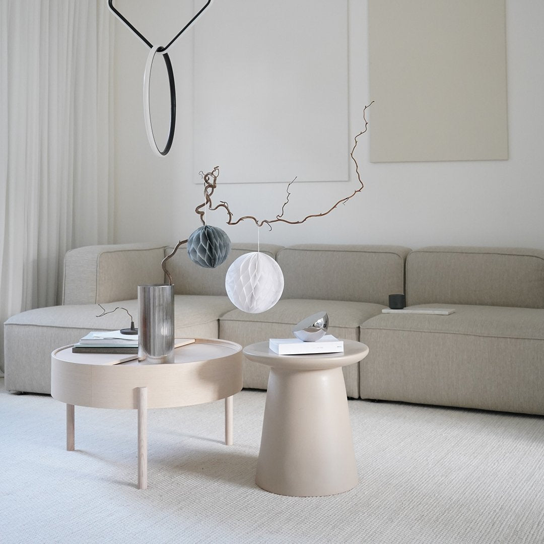 Modern beige coffee and side tables with minimalist design, set against a light, neutral-toned living space.