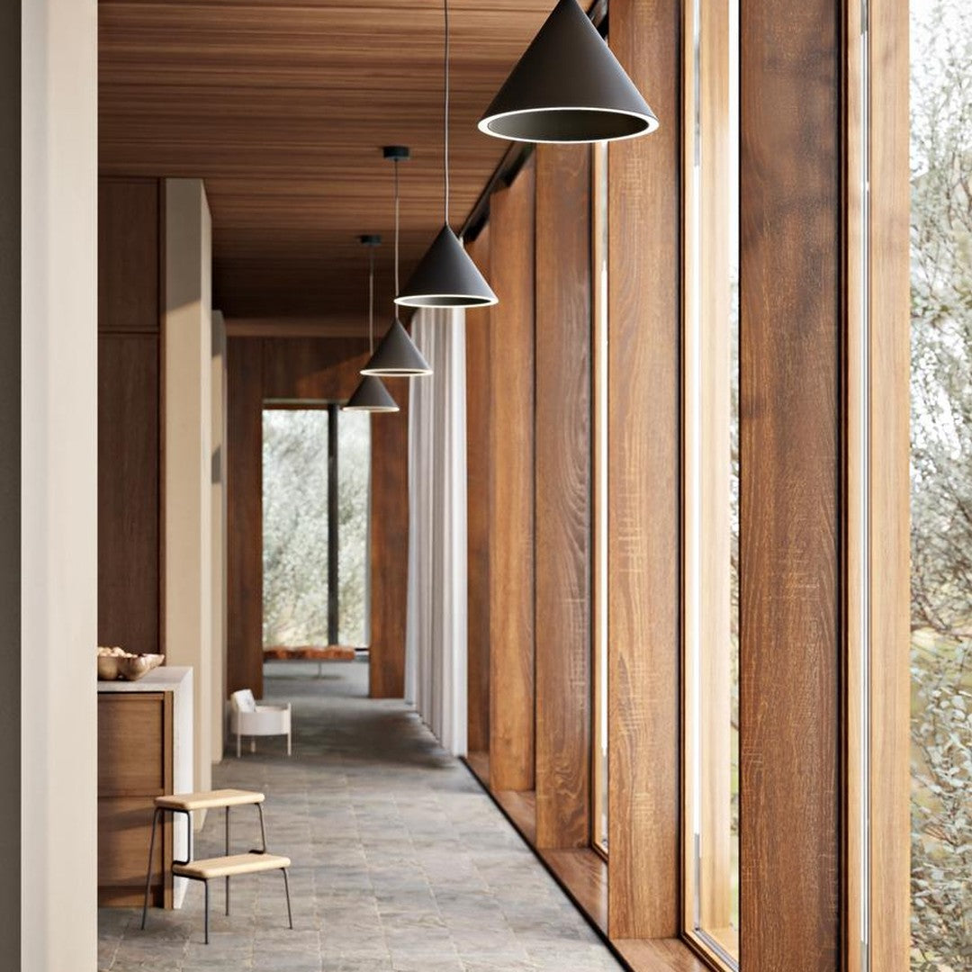 "Modern interior with warm wood tones, sleek black pendant lights, and light gray stone flooring."