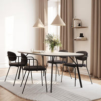 Modern dining table set with beige, gray, and black tones; featuring a textured light rug and elegant pendant lights.