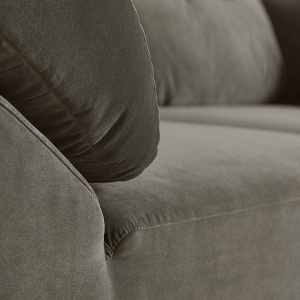 Dark olive green couch with soft, plush fabric and rounded cushions, perfect for modern living spaces.