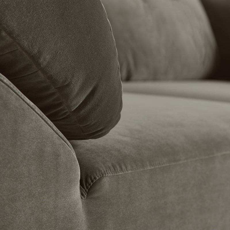 Soft brown fabric sofa with plush, textured cushions in a neutral color palette. Ideal for modern living spaces.