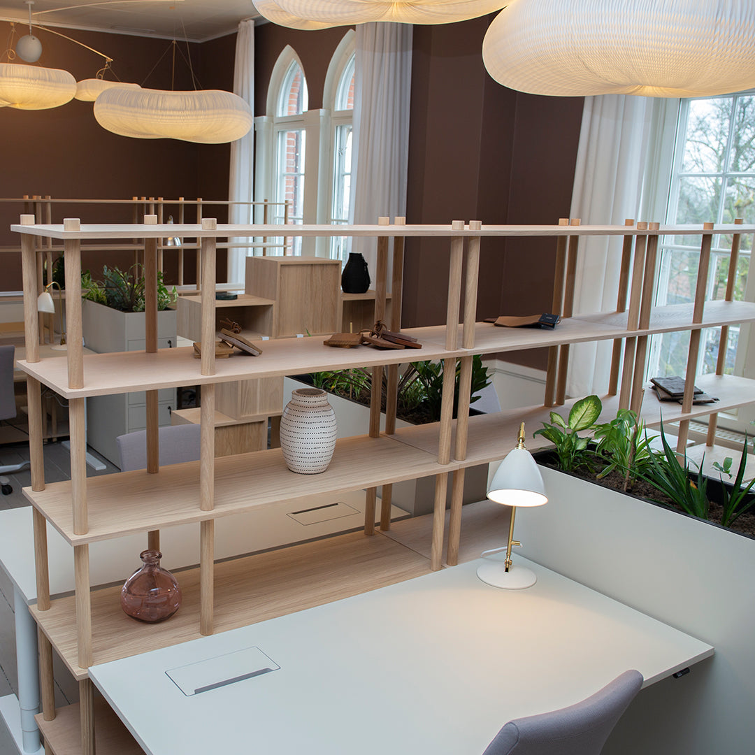 Light wood shelving unit with minimalist design, featuring soft neutrals and natural textures, perfect for modern spaces.
