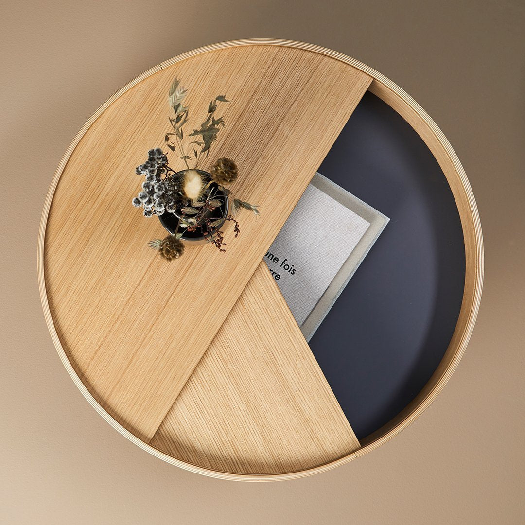 Round wooden tray featuring a split design with natural wood and deep navy blue sections. Decorative floral accents included.