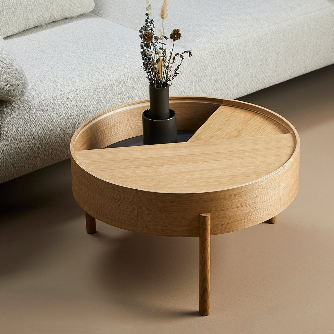 Light wood round coffee table with a circular, segmented top highlighting natural tones and smooth grain patterns.