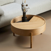 Light wood round coffee table with a circular, segmented top highlighting natural tones and smooth grain patterns.