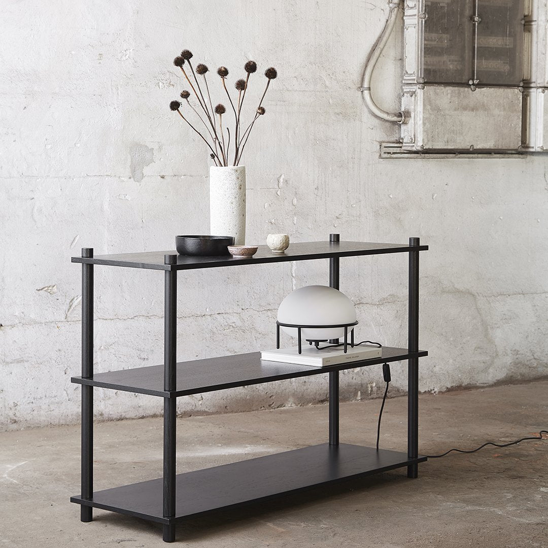 Minimalist black metal shelving unit with smooth surfaces and sleek lines. Perfect for modern decor.