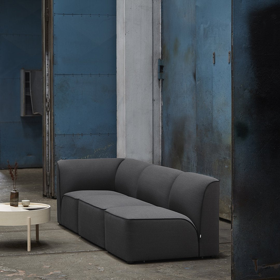 Gray modular sofa with a sleek, minimalist design in a modern urban setting. Ideal for contemporary decor.