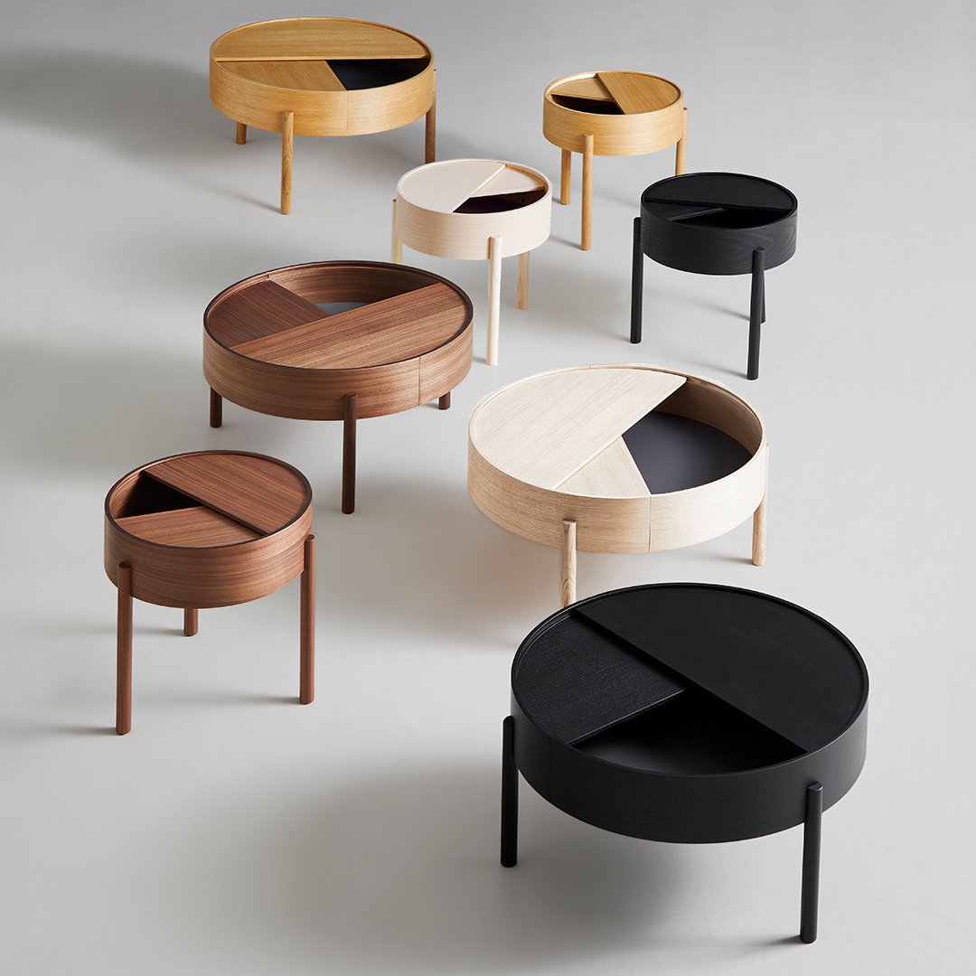 "Set of modern round tables in black, white, natural wood, featuring geometric split patterns."