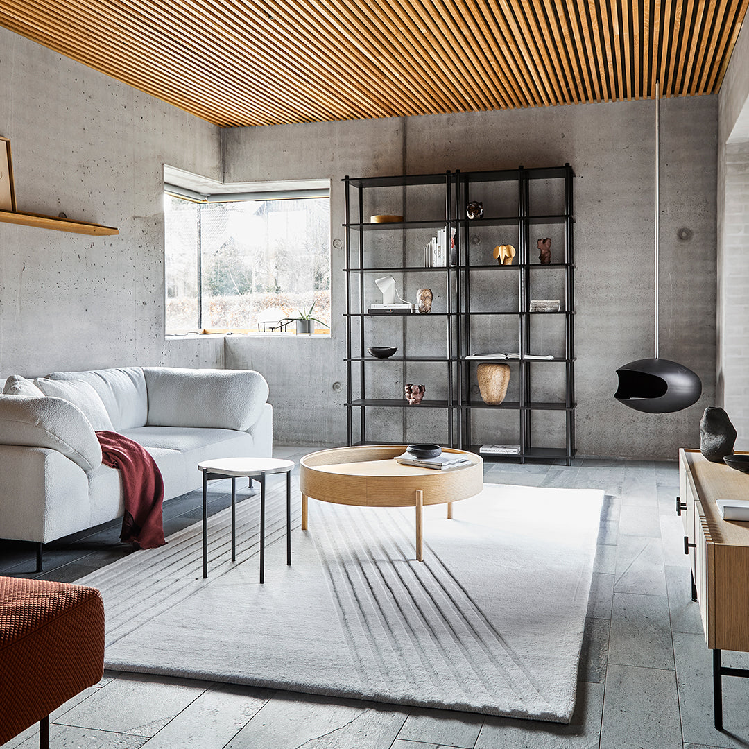 Modern living room featuring a mix of neutral tones, warm wood accents, and geometric patterns in furnishings.