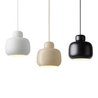 Three modern pendant lamps in white, beige, and black with sleek rounded shapes and minimalist design.