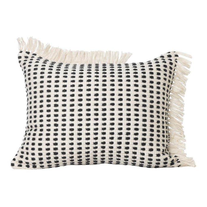 Black and cream patterned pillow with fringe, featuring a grid design on a textured background.