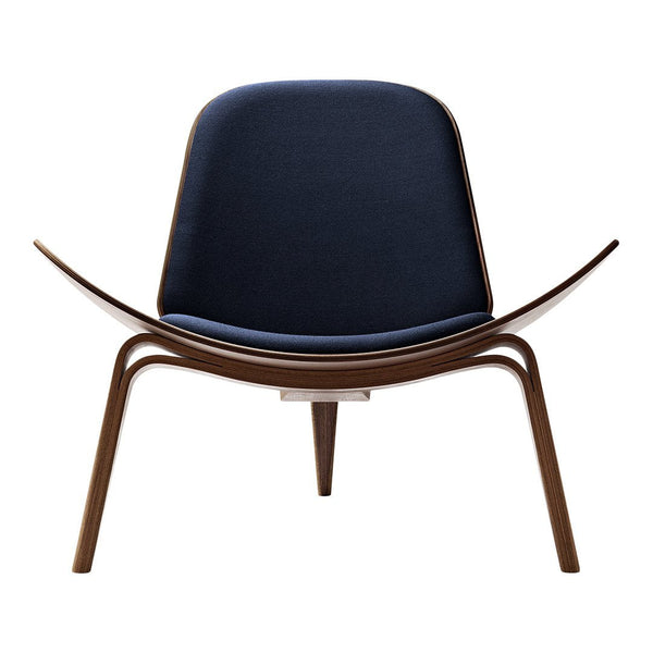 Navy blue upholstered chair with smooth wood accents, featuring a minimalist, contemporary design.