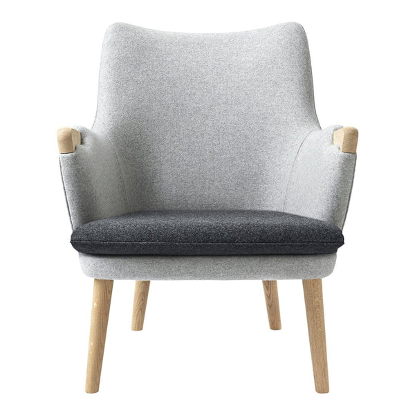 Gray and charcoal upholstered armchair with light wooden legs, featuring a sleek, minimalist design.
