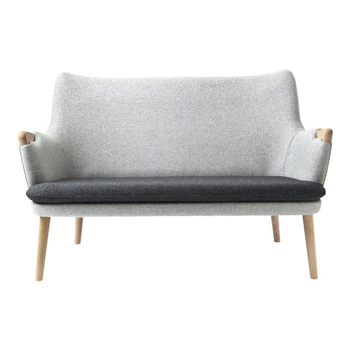 Light gray and dark gray two-tone sofa with wooden legs and a minimalist design. Perfect for modern decor.