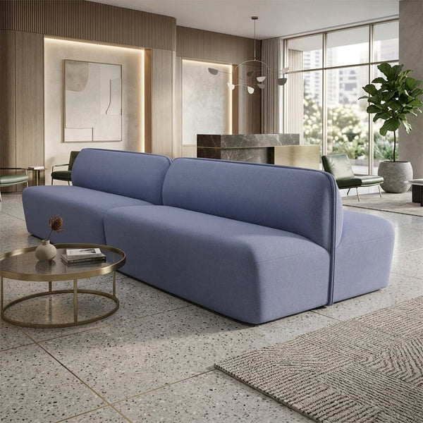 Modern light blue sofa with a minimalist design, featuring smooth lines and a soft fabric texture.