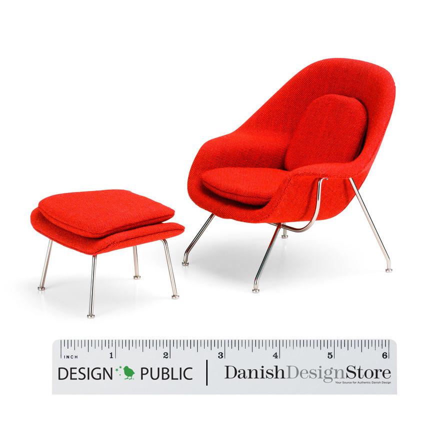 Vibrant red upholstered chair and ottoman with sleek metal legs, perfect for modern decor.