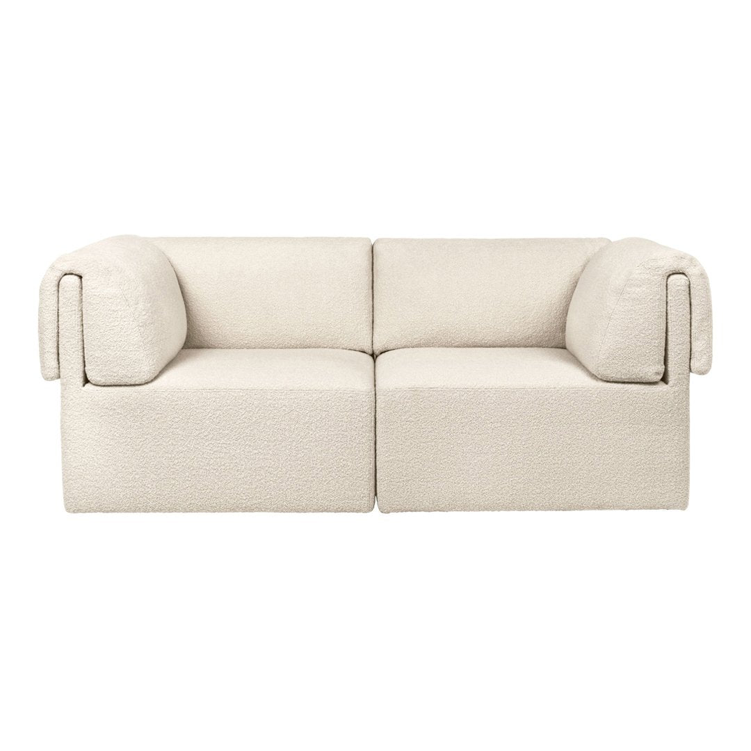 Beige two-seater sofa with a textured fabric and rounded arms, perfect for minimalist decor.
