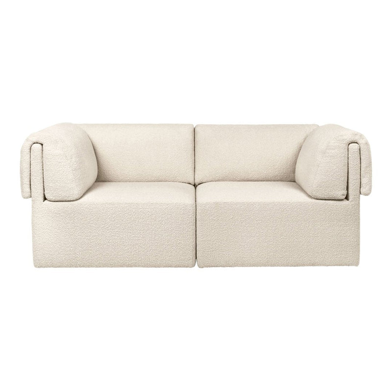 Beige two-seater sofa with a textured fabric and rounded arms, perfect for minimalist decor.