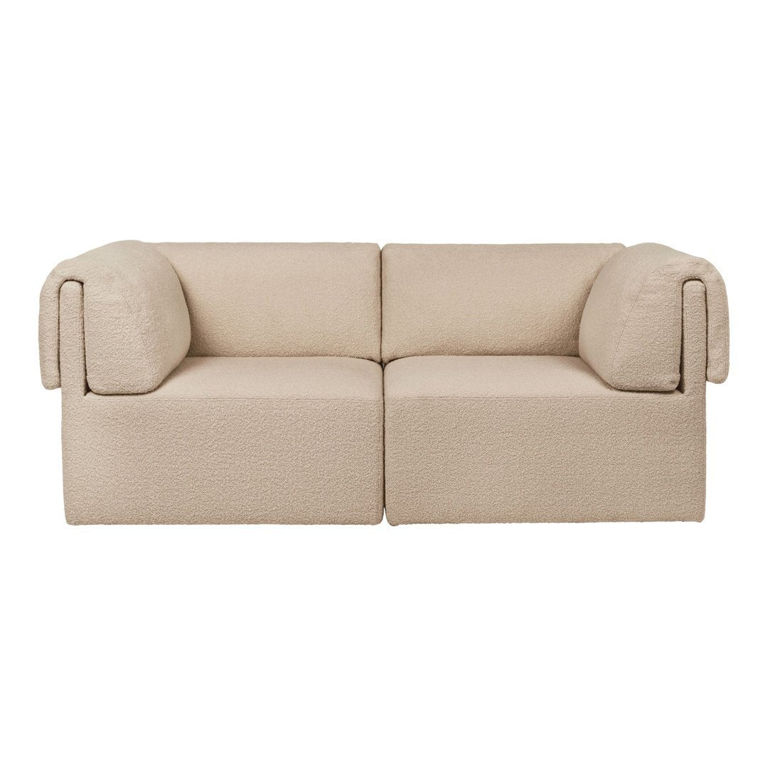Beige two-seater sofa with rounded armrests and a textured fabric pattern for a cozy and modern look.