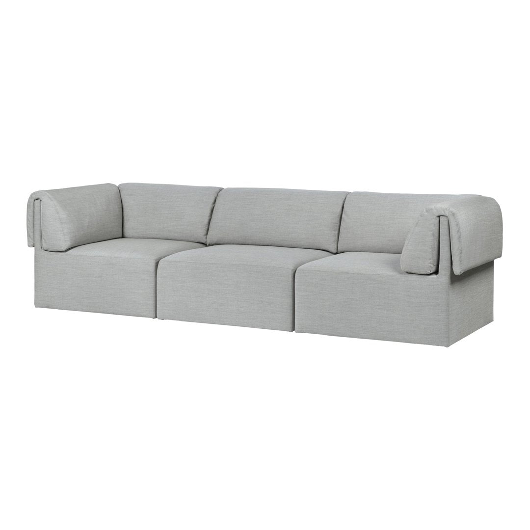 "Light gray sectional sofa with soft fabric and minimalistic design, featuring subtle texture and clean lines."