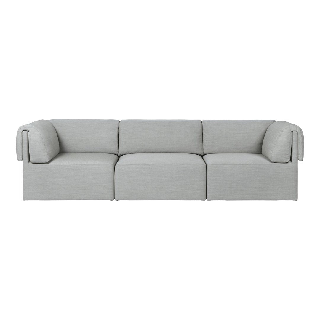 Light gray modular sofa with soft, textured fabric and minimalist design, featuring smooth lines and rounded edges.