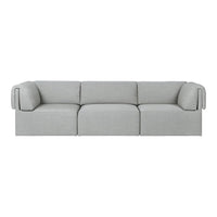 Light gray modular sofa with soft, textured fabric and minimalist design, featuring smooth lines and rounded edges.