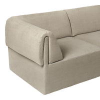 Beige upholstered sofa with a smooth, textured surface and minimalist design. Perfect for modern decor.