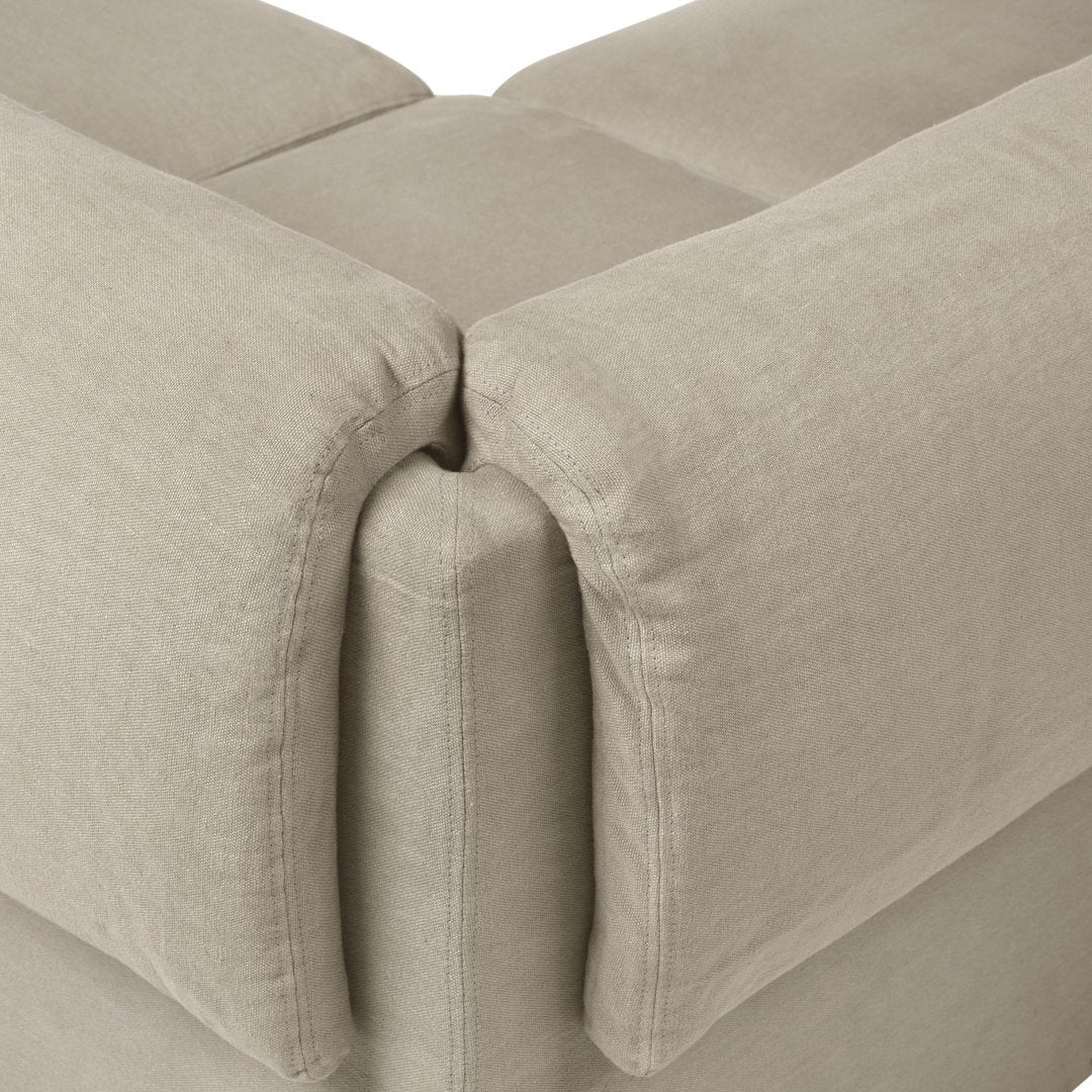 Light beige sofa corner with soft, textured fabric and clean lines, enhancing contemporary living spaces.