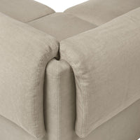 Light beige sofa corner with soft, textured fabric and clean lines, enhancing contemporary living spaces.