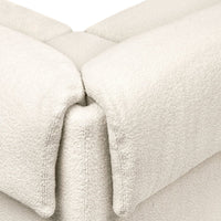 Soft, plush cream fabric with a textured pattern, perfect for cozy interiors.