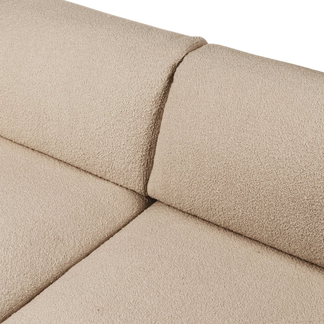 Beige textured upholstery with a soft, cozy finish, showcasing a seamless design for a modern look.