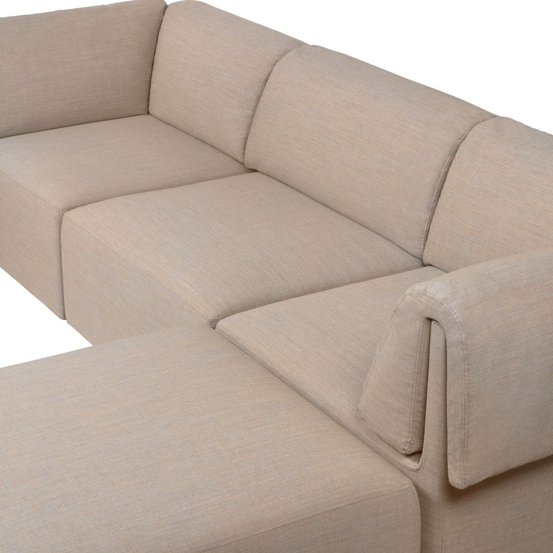 Beige sectional sofa with a smooth, textured fabric and minimalistic design, ideal for modern living rooms.