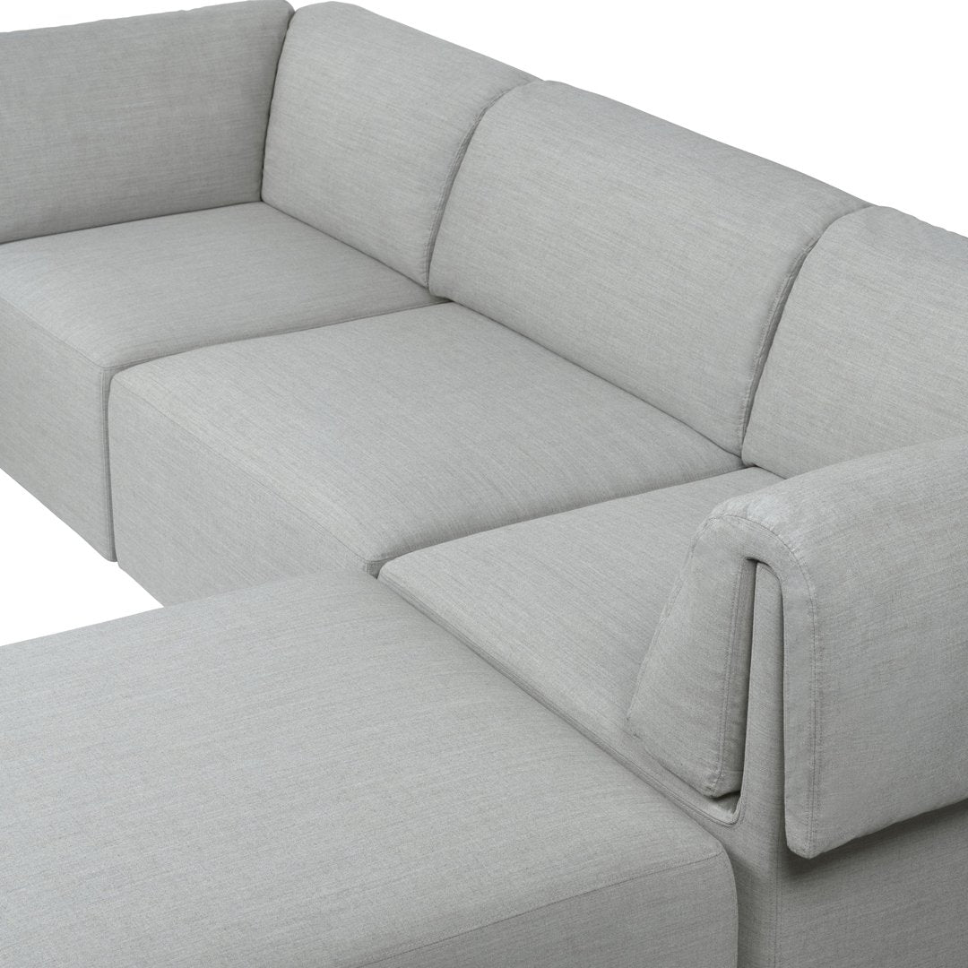 Grey sectional sofa with a sleek, minimalist design and subtle textured fabric pattern. Perfect for modern interiors.