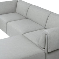 Grey sectional sofa with a sleek, minimalist design and subtle textured fabric pattern. Perfect for modern interiors.