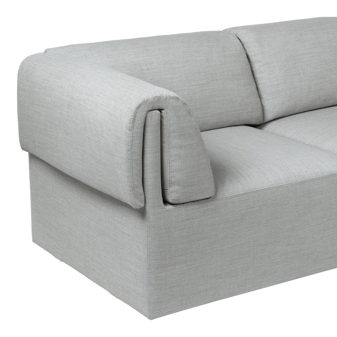 Light gray upholstered sofa with a smooth, textured fabric and minimalist design, featuring clean lines and a modern aesthetic.