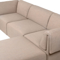 Beige sectional sofa with a textured, woven fabric pattern, offering a modern and cozy aesthetic.