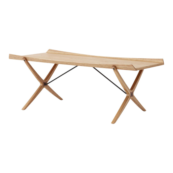 Natural wood coffee table with a light oak finish and sleek, minimalist design. Features a unique, curved surface and cross legs.