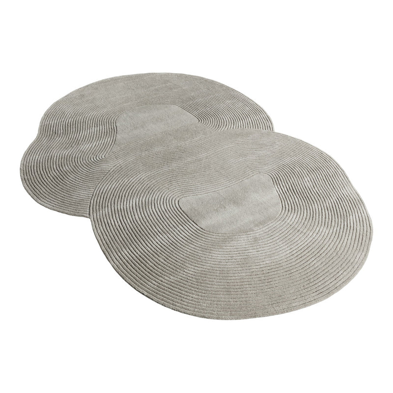 Gray woven placemats with subtle circular patterns, perfect for modern dining settings.