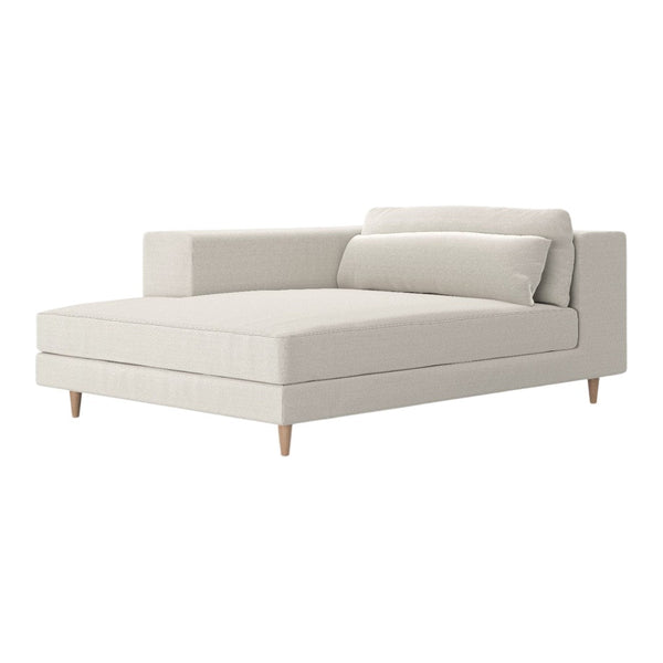 Soft beige chaise lounge with minimalist design and light wooden legs, featuring smooth, textured upholstery.