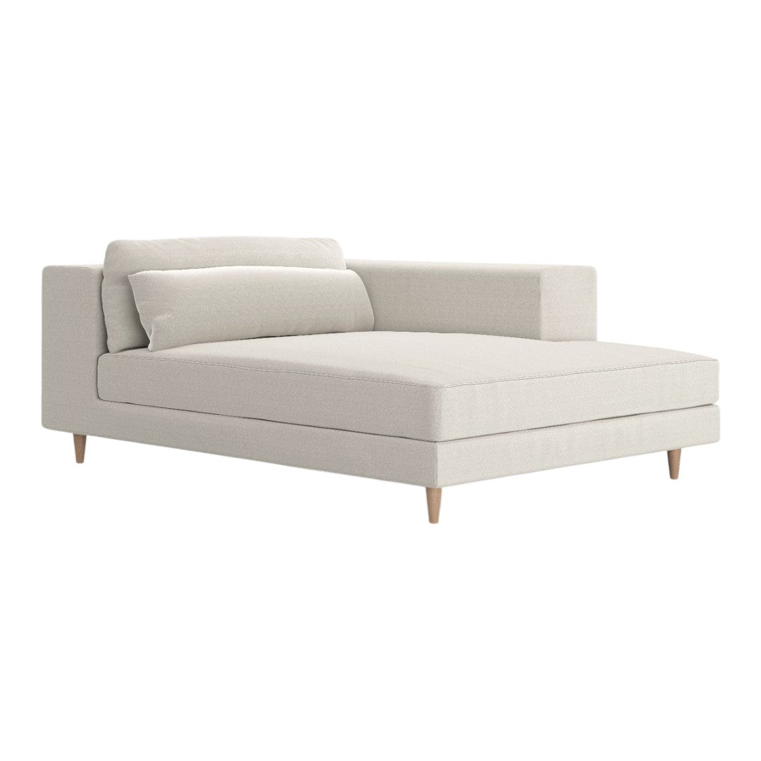 Light beige chaise lounge with a smooth fabric texture and minimalistic design, featuring natural wood legs.