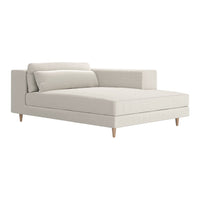 Light beige chaise lounge with a smooth fabric texture and minimalistic design, featuring natural wood legs.