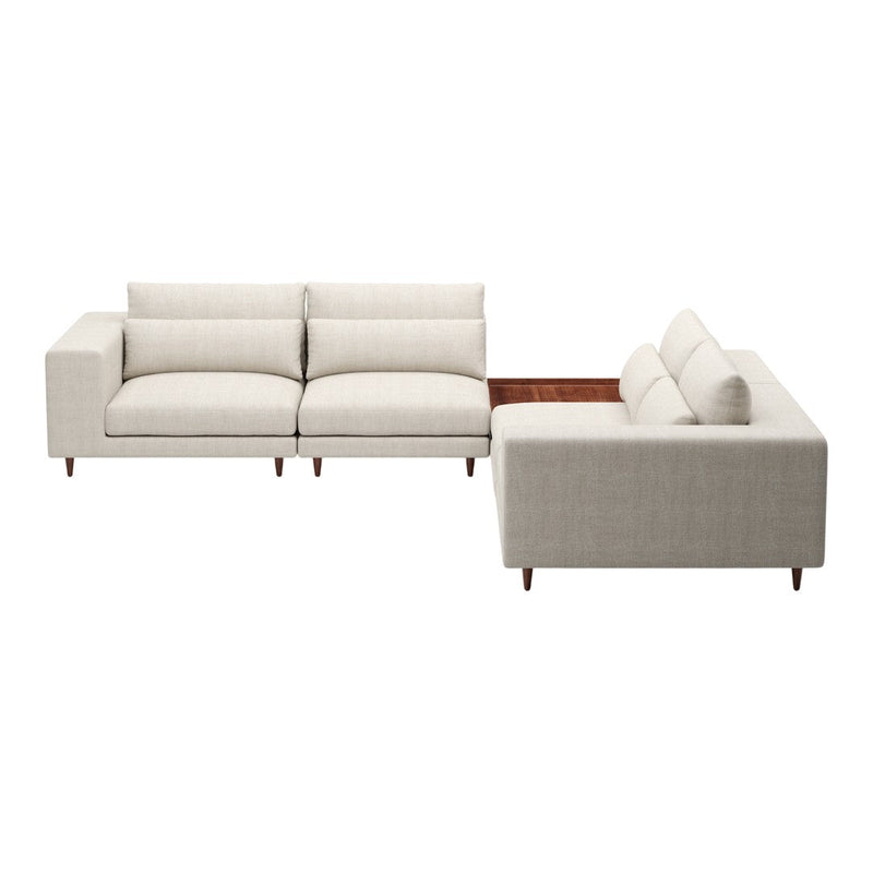 Light beige sectional sofa with subtle textured fabric and wooden accents for a modern, neutral aesthetic.