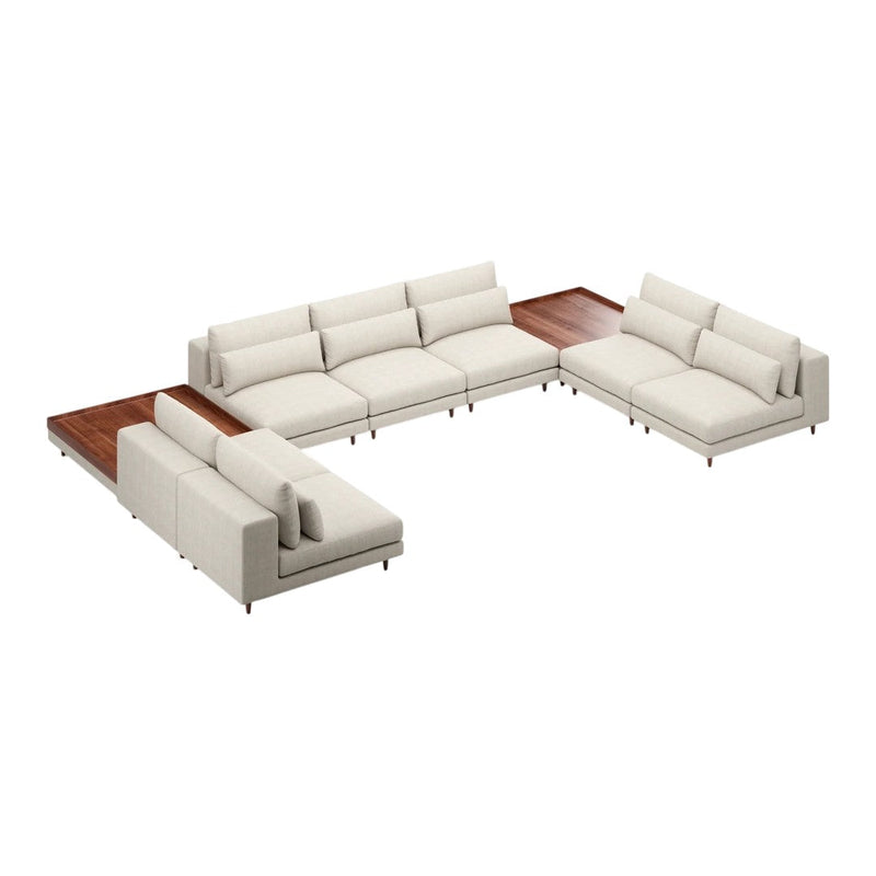 Light beige sectional sofa with plush cushions and a sleek wooden accent table, featuring a modern minimalist design.
